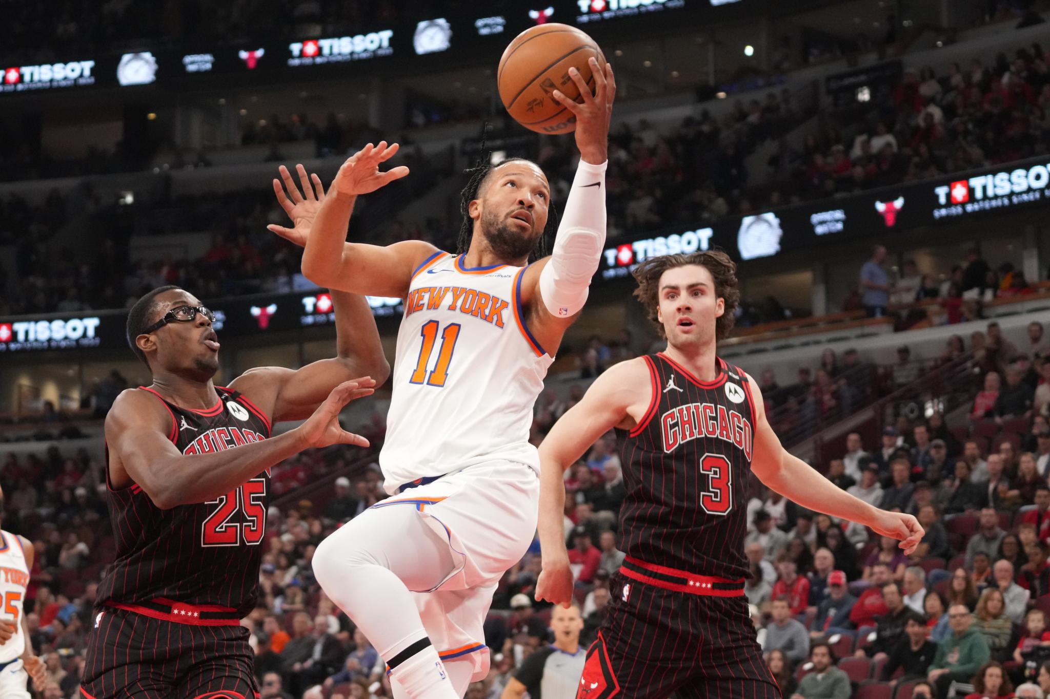 New York Knicks guard Jalen Brunson drives to the basket as Chicago Bulls forward Jalen Smith and guard Josh Giddey defend him.