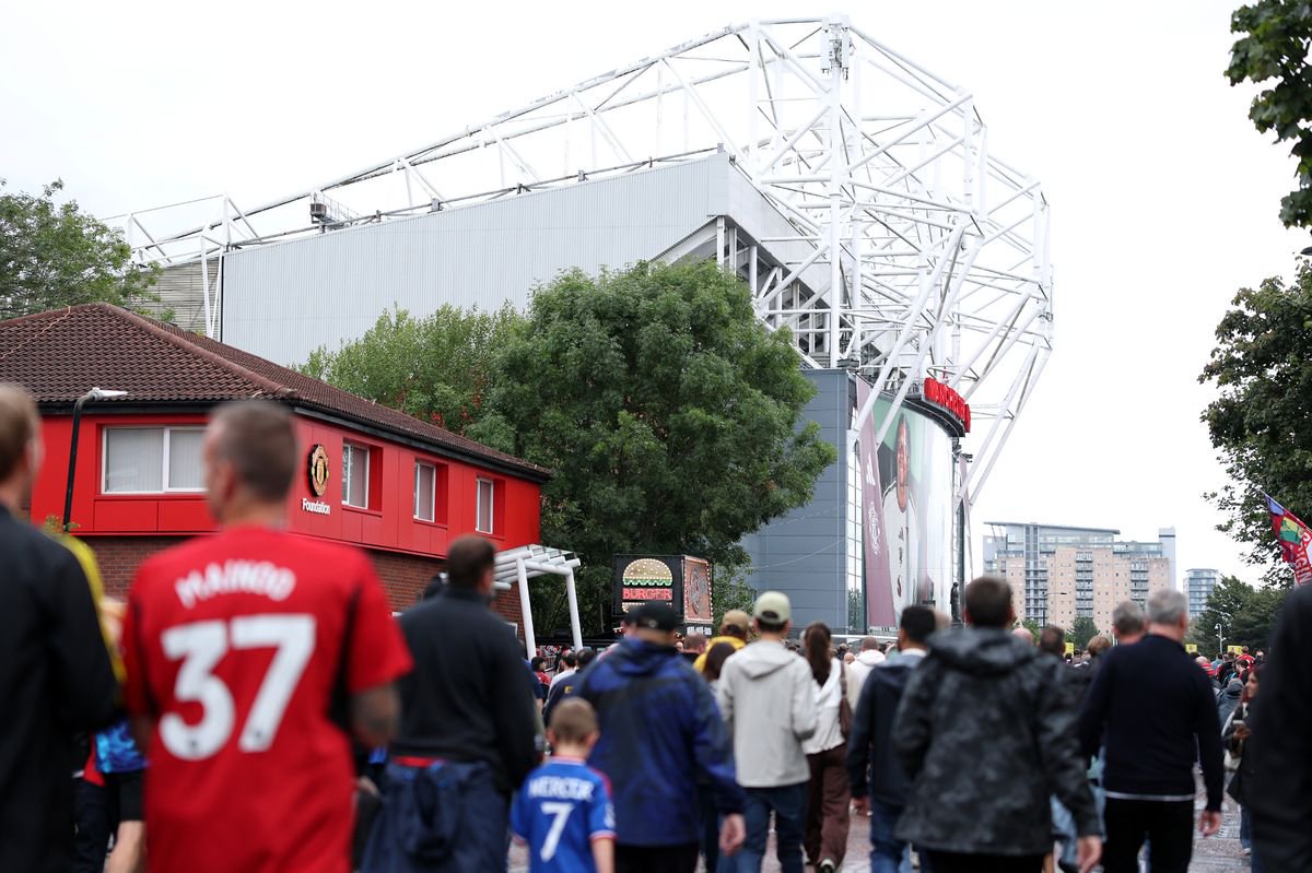 Fans walking up Sir Matt Busby towards Old Trafford in background