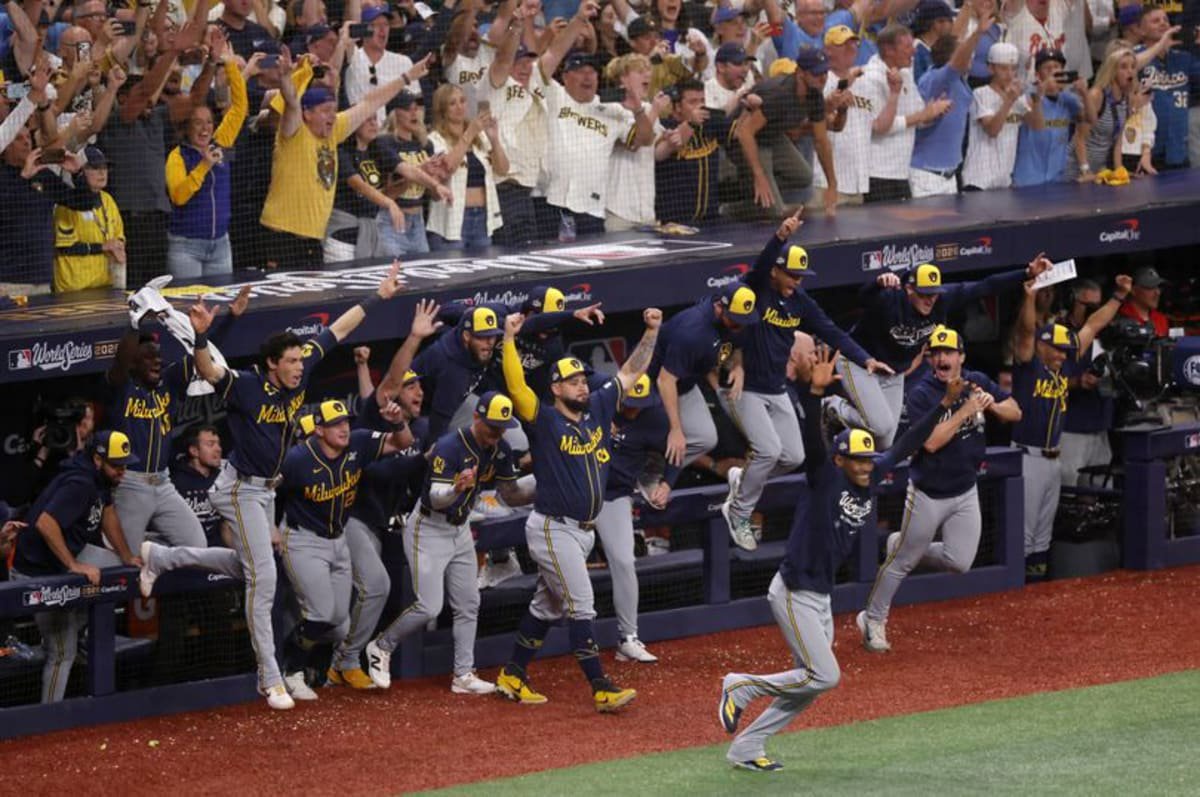 The Milwaukee Brewers run onto the field after winning the World Series