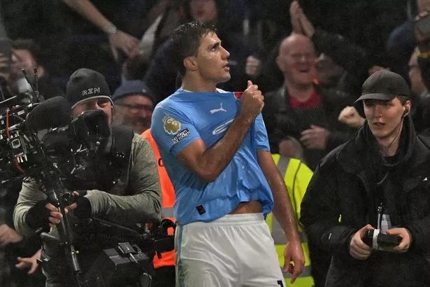 Manchester City's Spanish midfielder #16 Rodri celebrates after his deflected shot makes it 3-4 to City during the English Premier League football match between Chelsea and Manchester City