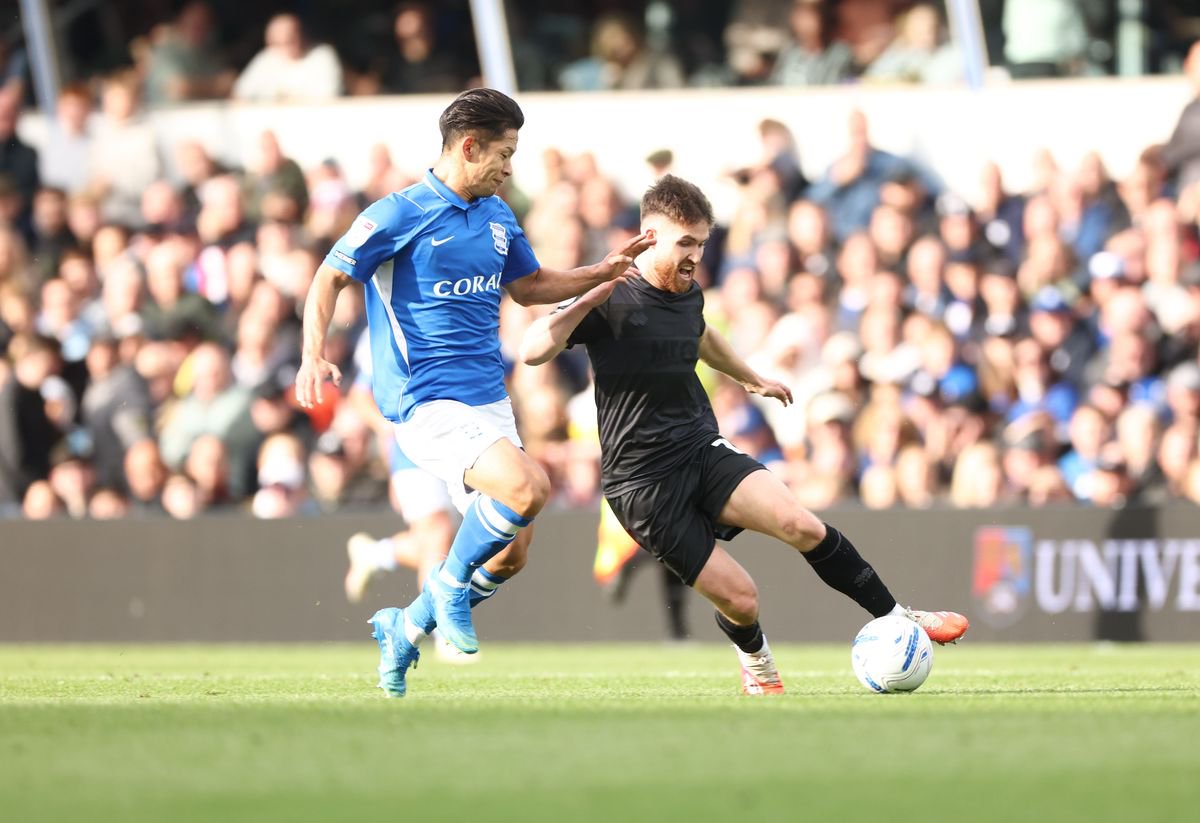 Birmingham City's Tomoki Iwata challenges Queens Park Rangers' Paul Smyth