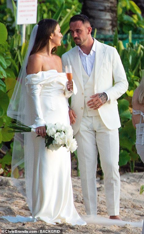 Wedding bells: Aston Villa player Danny Ings, 30, cut a dapper figure in an ivory white suit as he got married in Barbados on Friday
