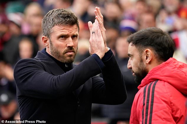 Manchester United's head coach Michael Carrick applauds to supporters ahead of the start of the English Premier League soccer match between Manchester United and Bournemouth in Manchester, England, Sunday, Oct. 25, 2026. (AP Photo/Dave Thompson)