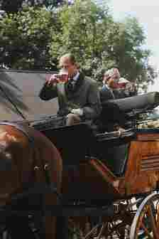 Prince Philip the Duke of Edinburgh refreshes himself with a beer during a carriage driving event 1980