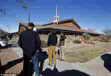 Armed private security guards stand outside a Mormon church