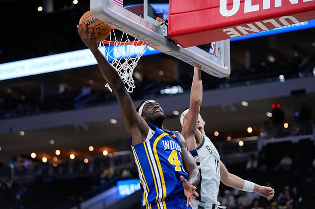 Indiana Pacers forward Pascal Siakam, left, goes up to score against Milwaukee Bucks guard Tyler Herro, right, during the first half of an NBA basketball game Monday, Oct. 26, 2026, in Milwaukee. (AP Photo/Kayla Wolf)