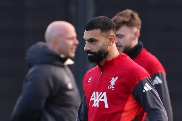 Mohamed Salah looks on as Arne Slot oversees Liverpool's training session on Monday
