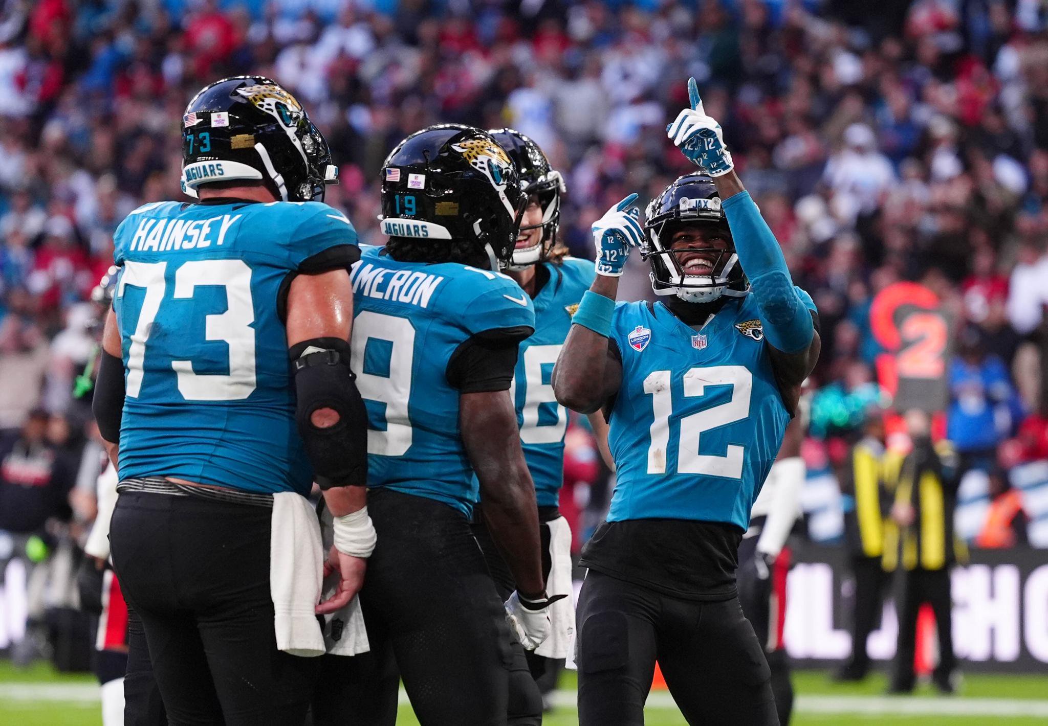 Jacksonville Jaguars' Travis Hunter (right) celebrates with team mates after scoring a touchdown during the NFL London Games match at Wembley Stadium, London. 