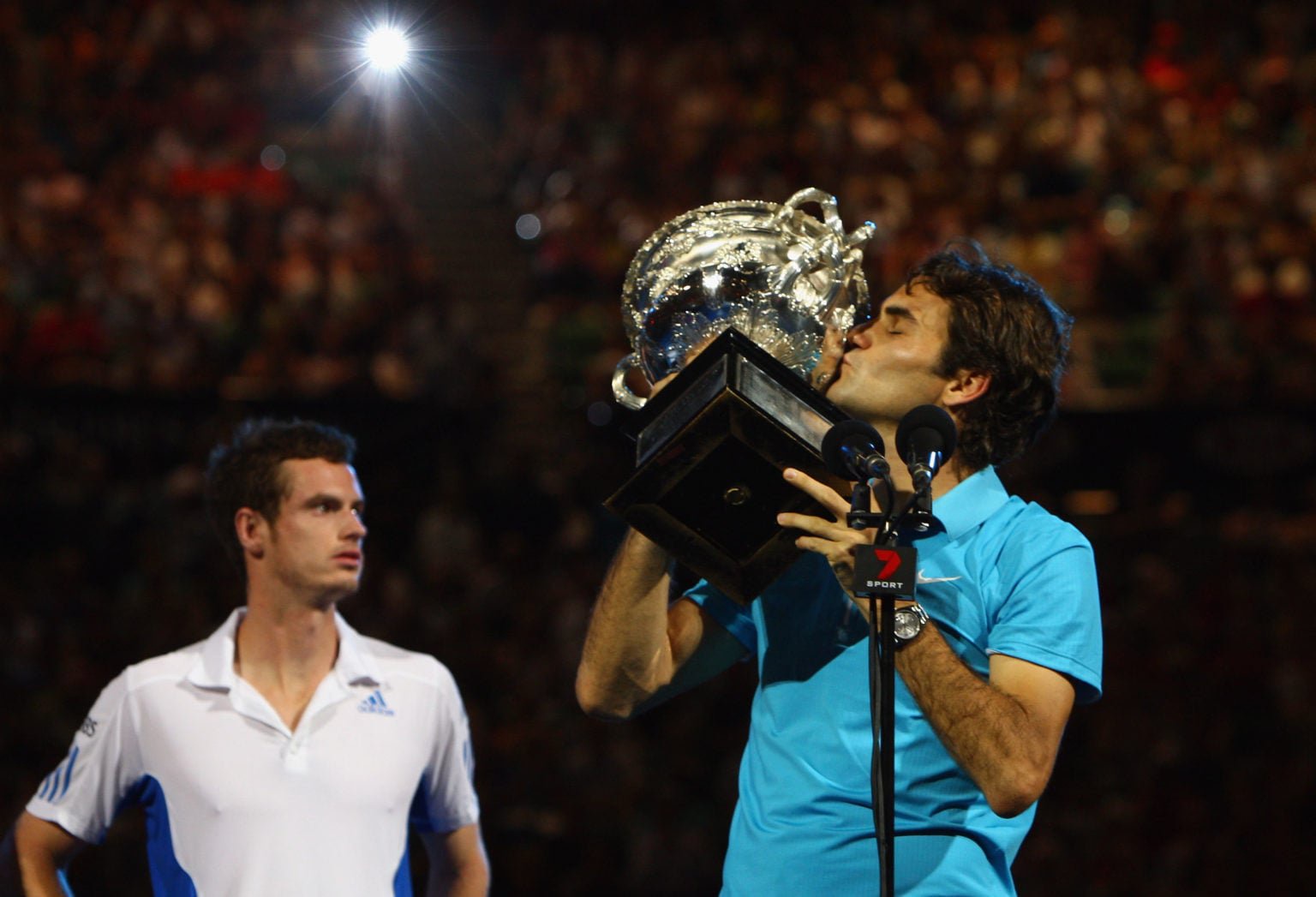Roger Federer kisses the Australian Open title.