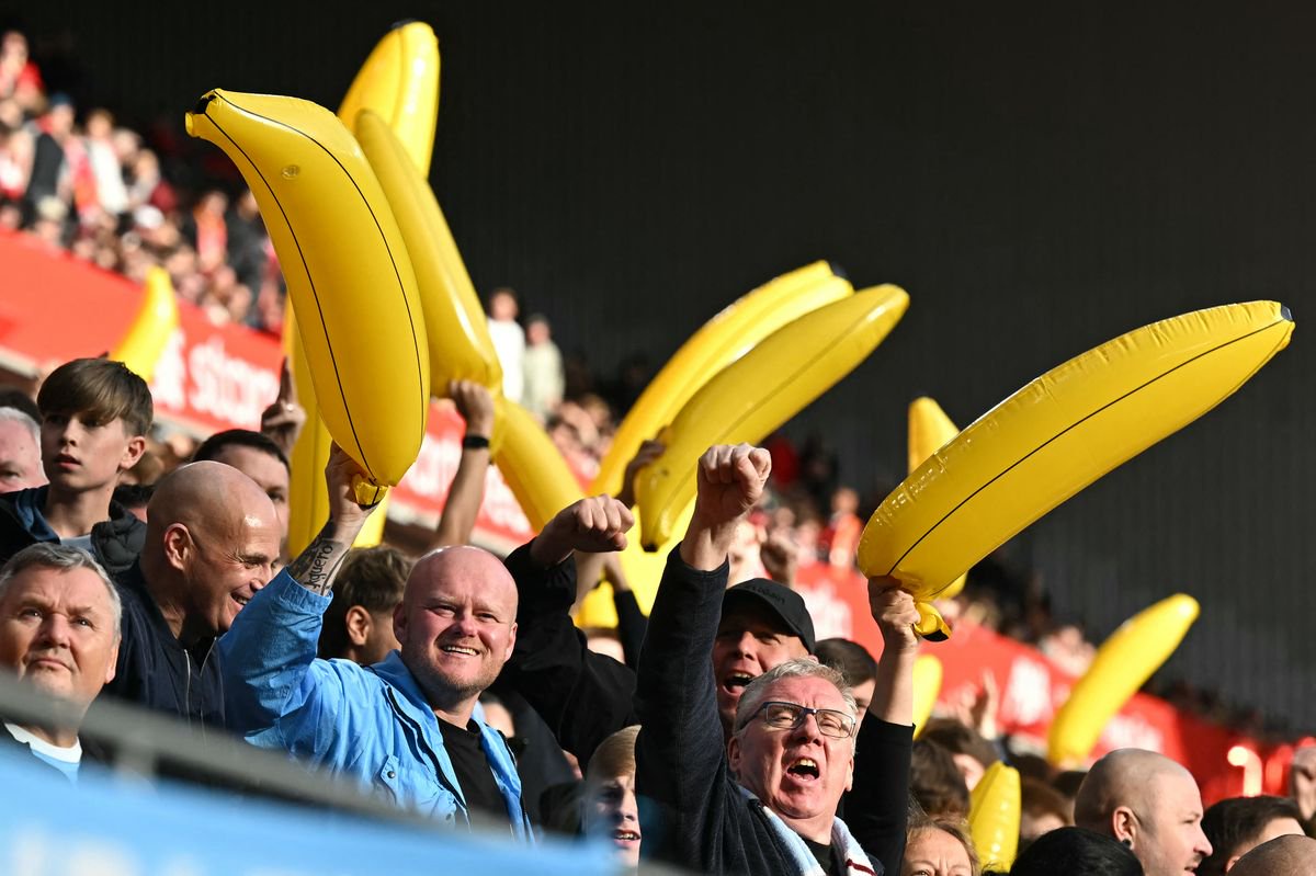 City fans wave inflatable bananas in the crowd ahead of the English Premier League football match between Liverpool and Manchester City
