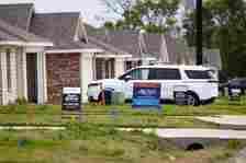 For sale signs in front of a home that are part of a residential development by Dallas...