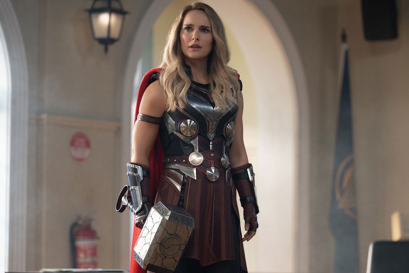 Image may contain Natalie Portman Clothing Costume Person Lamp Adult Cape Cosplay Gun Weapon and Glove