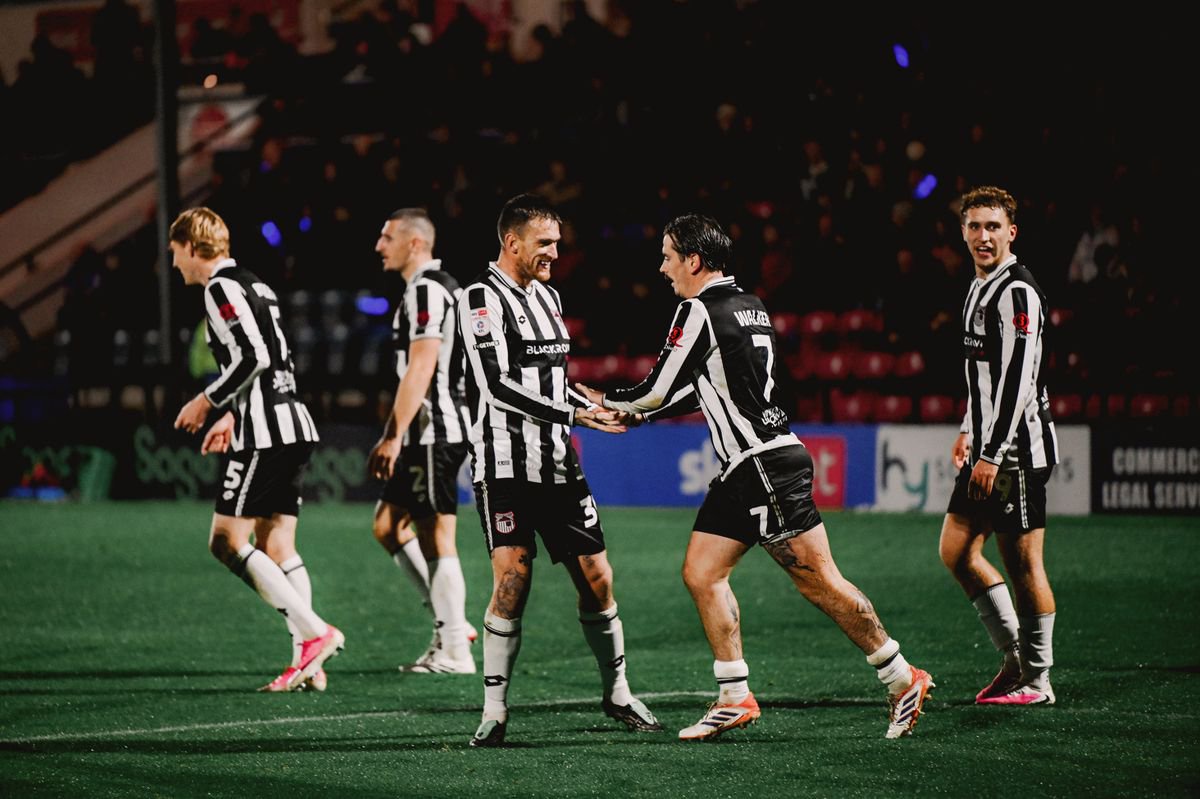 Grimsby Town's Jamie Walker scores during the match against Rochdale