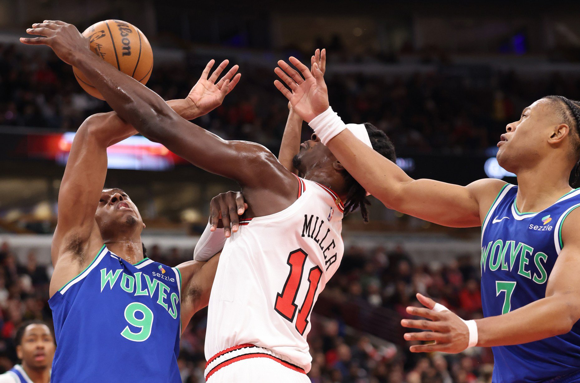 Bulls forward Leonard Miller (11) is fouled by Timberwolves forward Cody Williams (9) in the second quarter of a preseason game at the United Center on Oct. 16, 2026, in Chicago. (John J. Kim/Chicago Tribune)