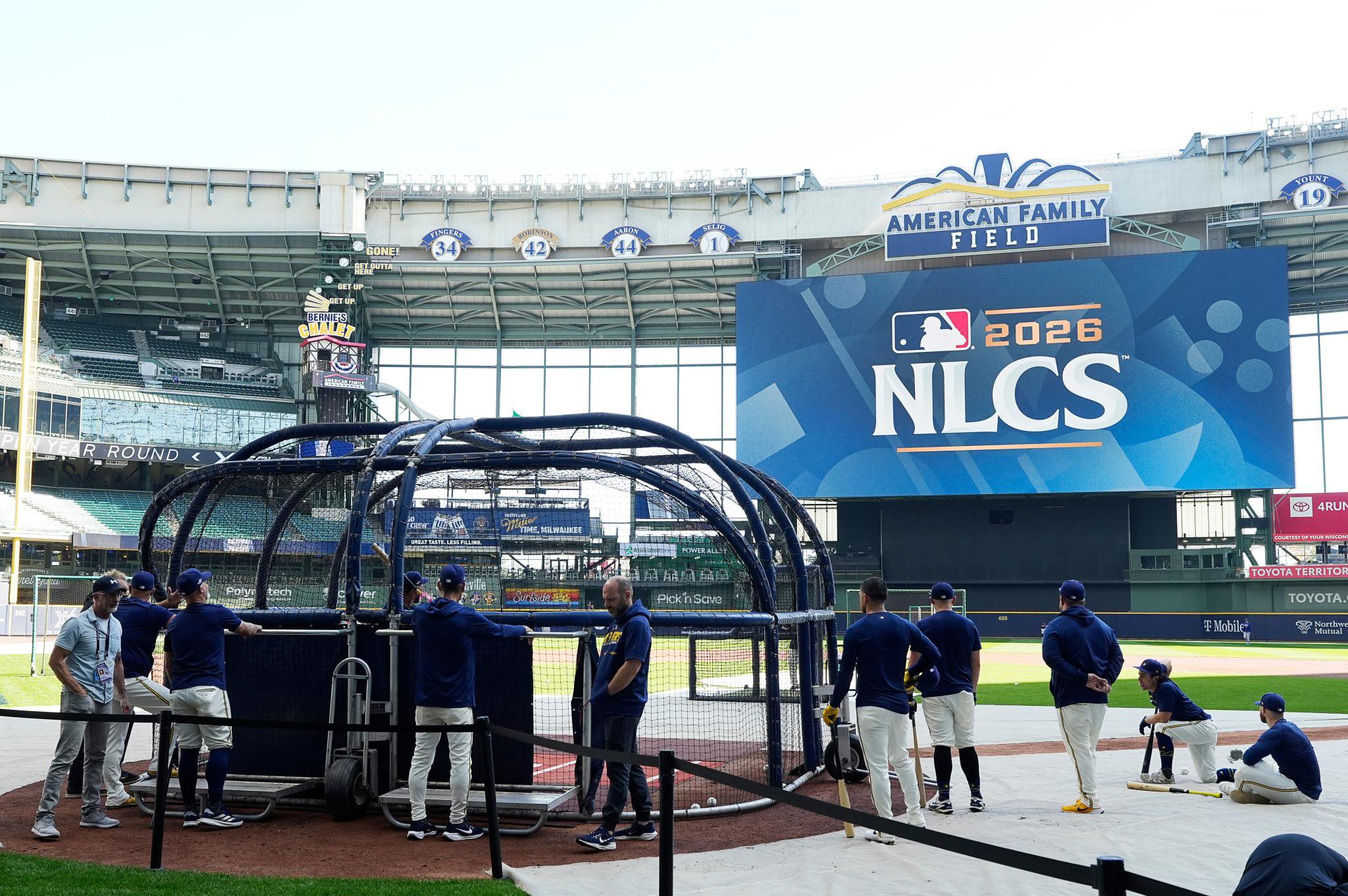Milwaukee Brewers players take batting practice on the field at American Family Field before a National League Championship Series game.