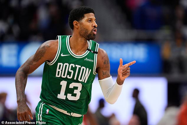 Boston Celtics forward Paul George (13) points after hitting a shot against the Detroit Pistons in the second half of an NBA basketball game in Detroit, Tuesday, Oct. 20, 2026. (AP Photo/Paul Sancya)