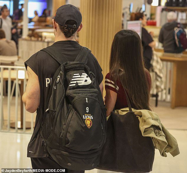 The new Collingwood Magpies recruit was making his way to his new home state of Victoria, but his loyalty to the Lions was still apparent, with the midfielder carrying a backpack from the club