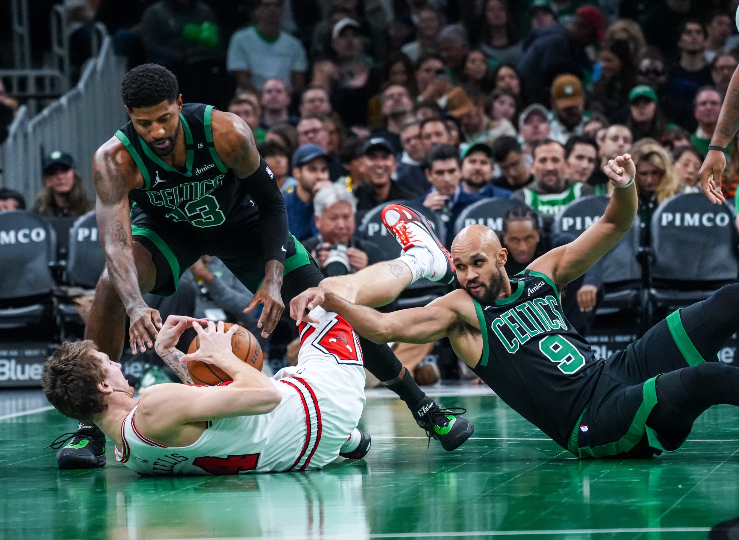 Oct 30, 2026; Boston, Massachusetts, USA; Chicago Bulls forward Matas Buzelis (14) works for the ball against Boston Celtics forward Paul George (13) and guard Derrick White (9) in the second half at TD Garden. Mandatory Credit: David Butler II-Imagn Images