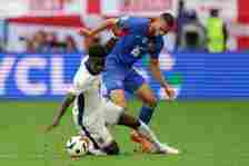 Bukayo Saka of England and David Hancko of Slovakia in action during the UEFA EURO 2024 round of 16 match between England and Slovakia at Arena AufSchalke