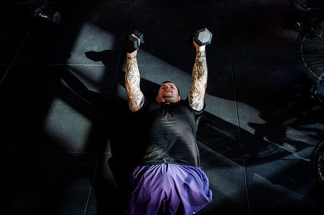 Dmytro Bykhovchenko, a Ukrainian war veteran, trains in a gym for the upcoming HYROX competition in Valencia, in Kyiv, Ukraine, Sunday, Oct. 11, 2026. (AP Photo/Evgeniy Maloletka)