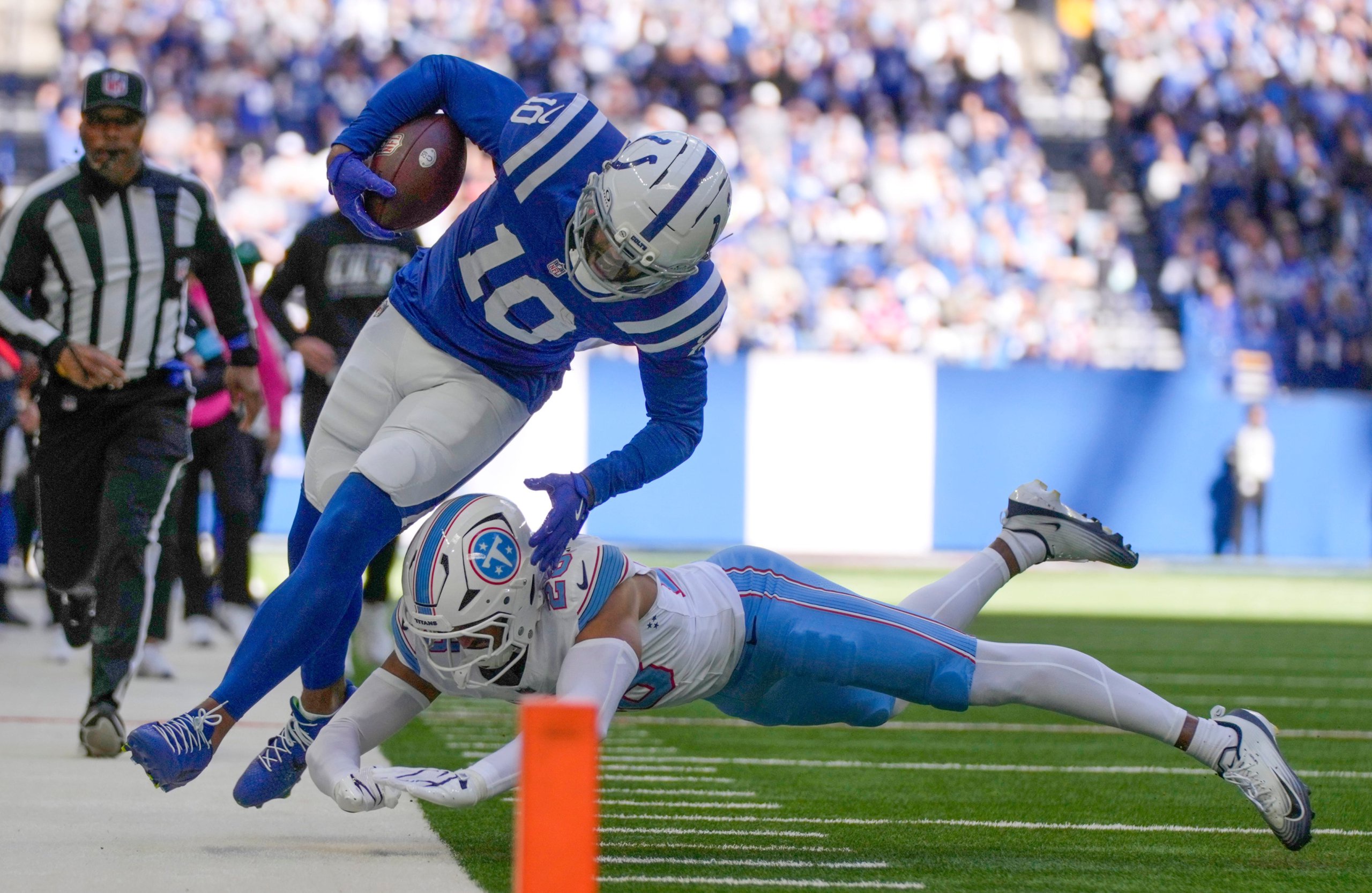 Indianapolis Colts wide receiver Keenan Allen (10) is pushed out of bounds Sunday, Oct. 18, 2026, by Tennessee Titans safety