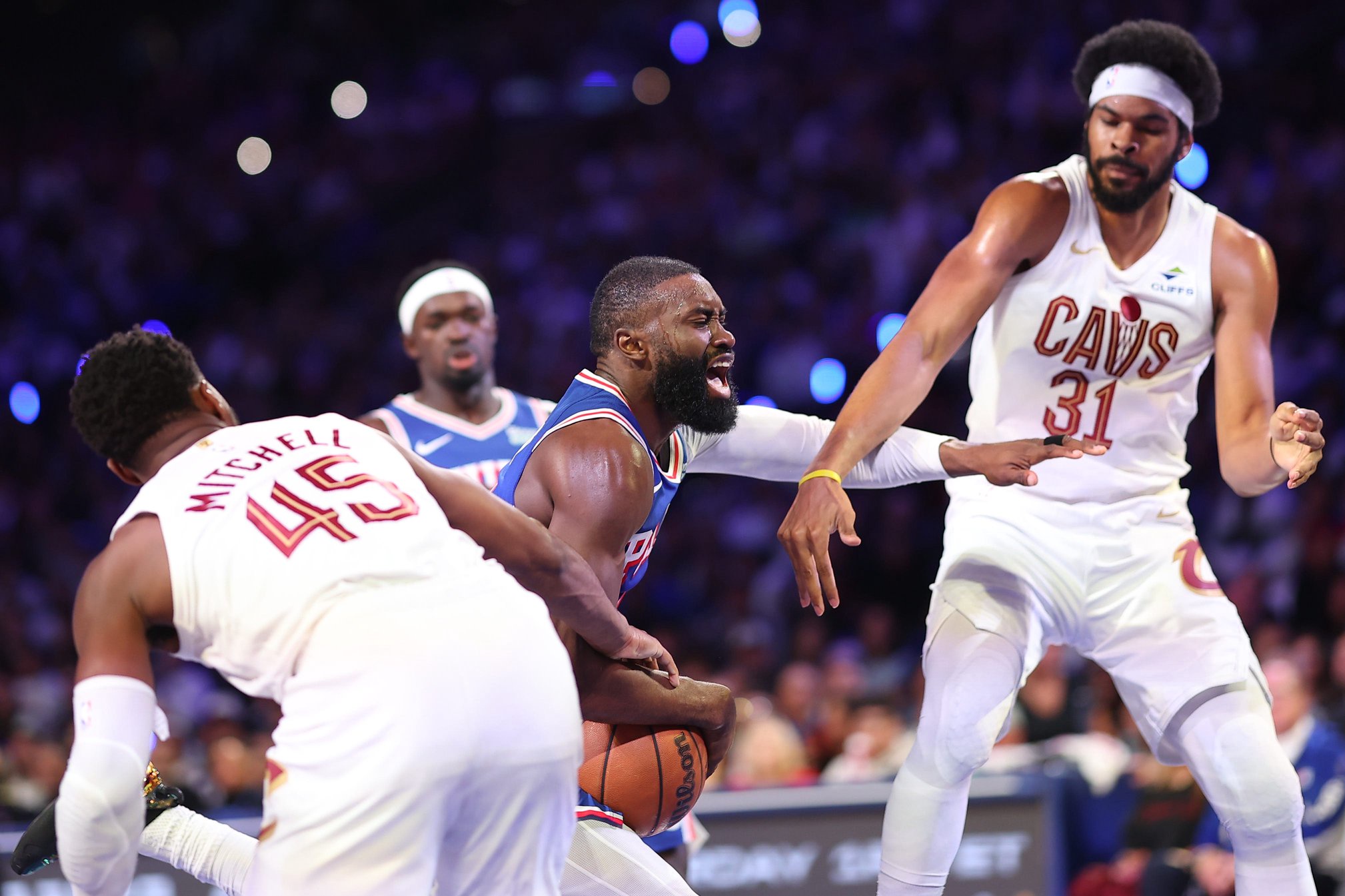 Cleveland Cavaliers guard Donovan Mitchell  and center Jarrett Allen (31) defend as Philadelphia 76ers guard Jaylen Brown (7) drives to the rim Oct. 22, 2026, in Philadelphia, Pennsylvania.