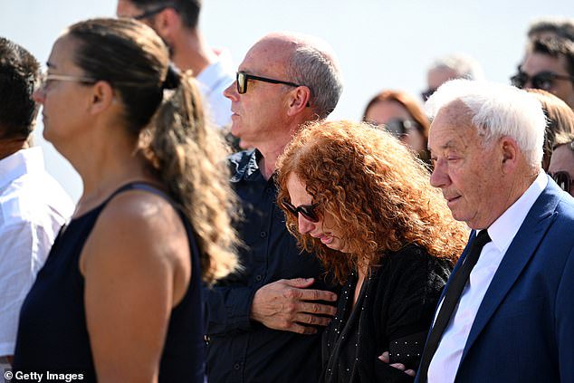 Joaquim Silva, father of Jota and Silva, consoled his wife Isabel Silva, as the family arrived in procession at the funeral