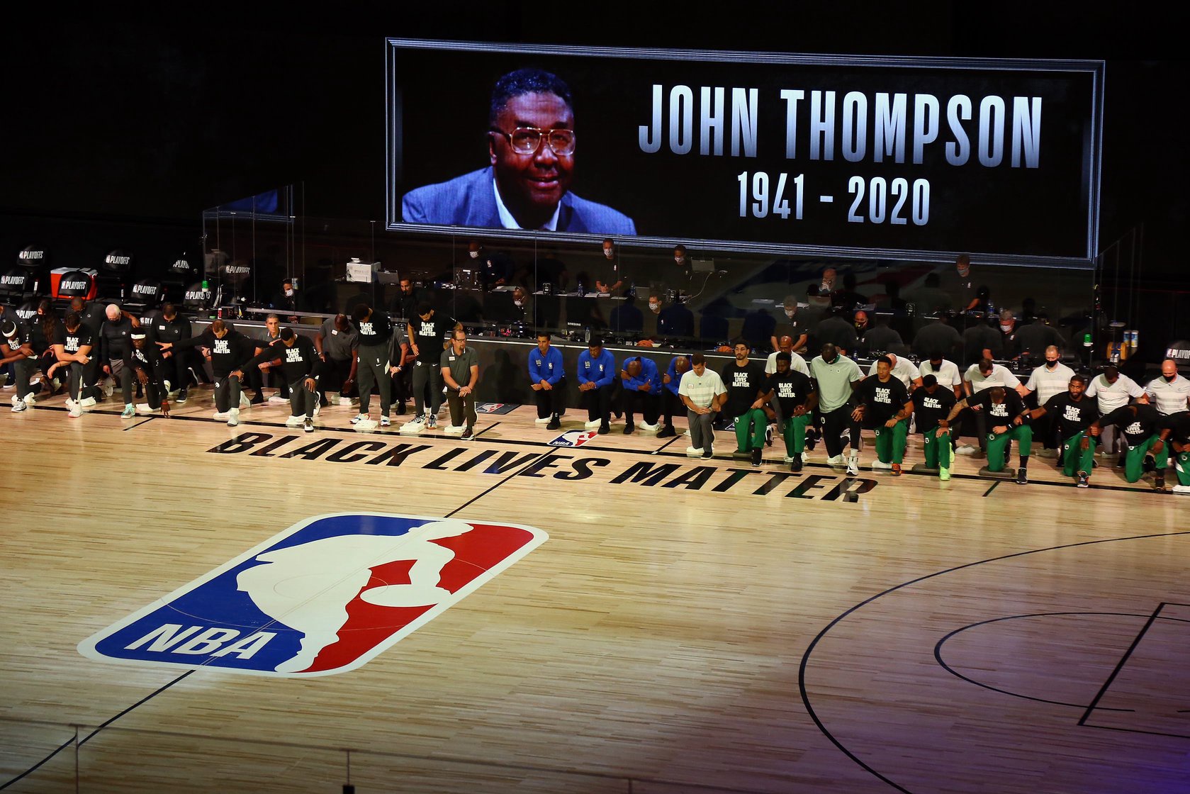 Sep 1, 2020; Lake Buena Vista, Florida, USA; Members of the Toronto Raptors and the Boston Celtics kneel as late Georgetown Hoyas coach John Thompson is remembered before game two of the second round of the 2020 NBA Playoffs at ESPN Wide World of Sports Complex. Mandatory Credit: Kim Klement-USA TODAY Sports