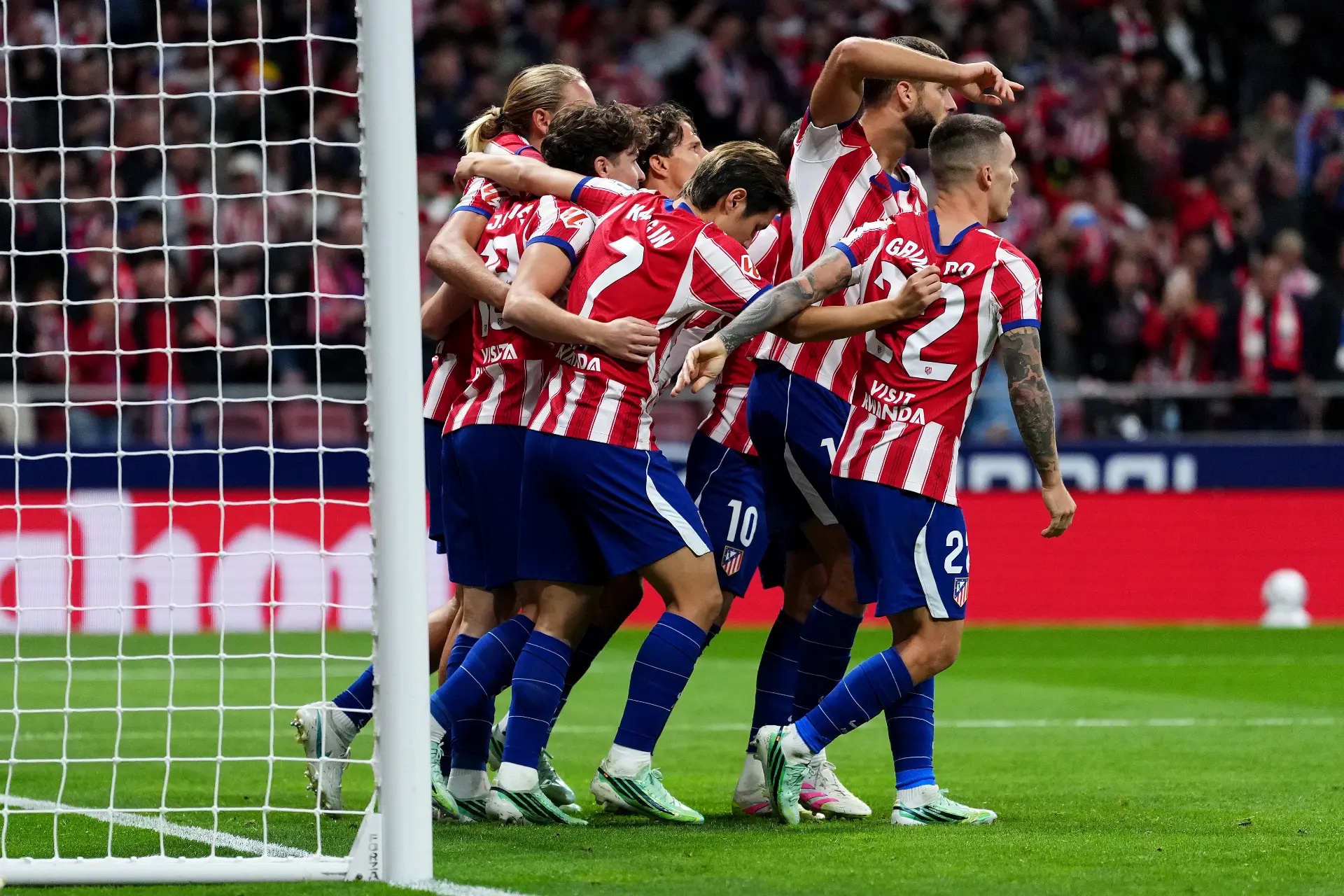 Julián Alvarez getting swamped by his teammates.