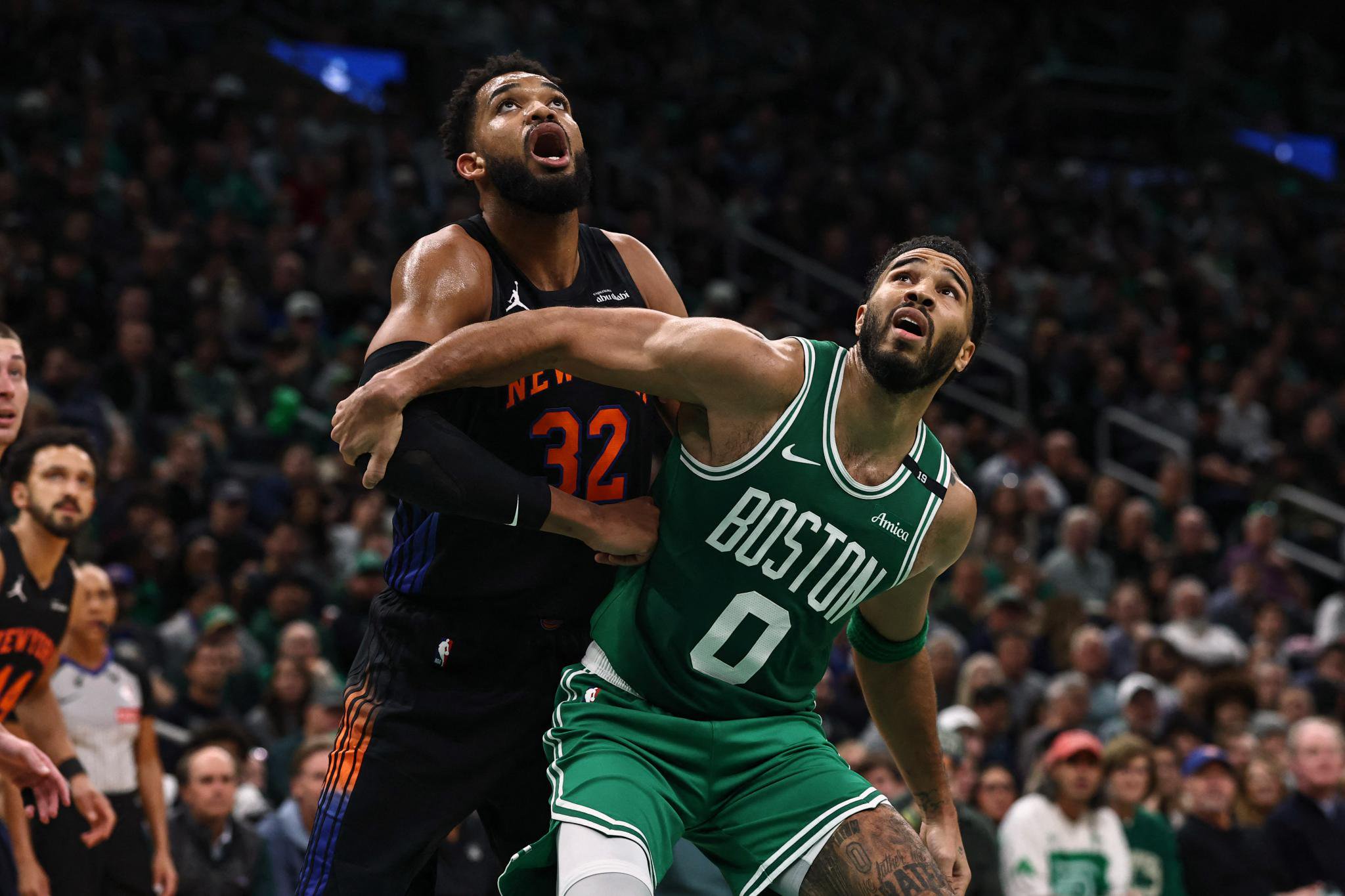 Boston Celtics forward Jayson Tatum battles for position with New York Knicks center Karl-Anthony Towns.