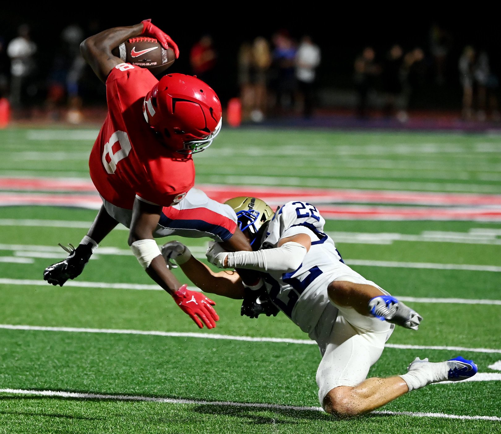 Brentwood's Turner Weber (22) upends Brentwood Academy's Braylen Bedford (8) during a TSSAA high school football game at Brentwood Academy on Friday, Aug. 28, 2026, in Brentwood, Tenn.