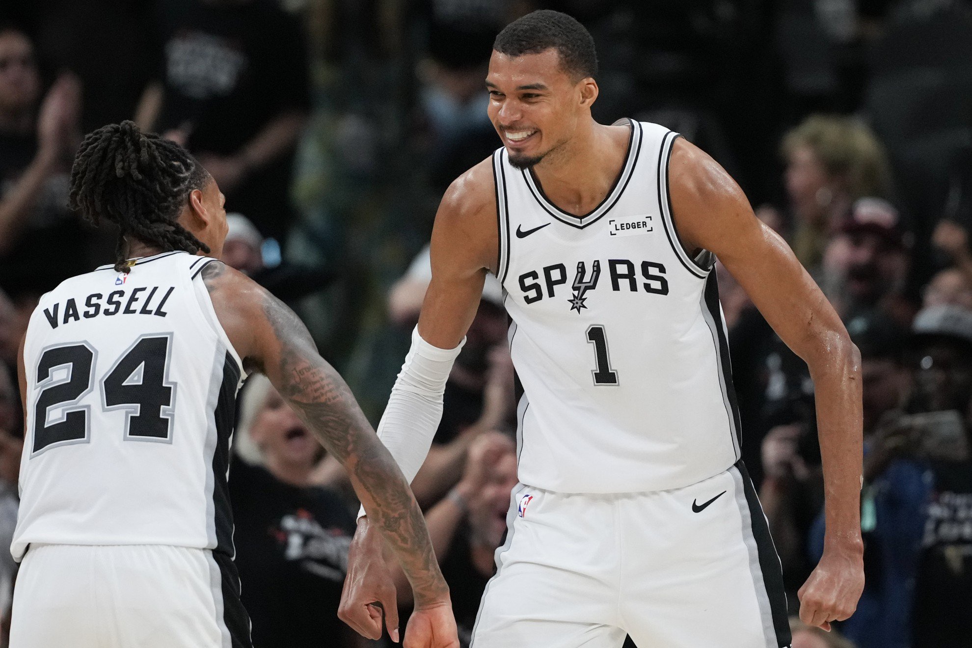 San Antonio Spurs forward/center Victor Wembanyama (1) reacts with guard/forward Devin Vassell (24) /