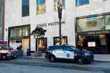 FILE - Police officers and emergency crews park outside the Louis Vuitton store in San Francisco's Union Square on Nov. 21, 2021, after looters ransacked businesses. Facing mounting pressure to crack down on a retail theft crisis, California lawmakers are split on how best to tackle the problem that some say had caused major store closures and products like deodorants to be locked behind plexiglass. (Danielle Echeverria/San Francisco Chronicle via AP, File)