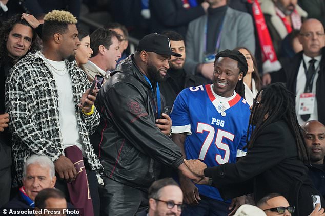 New Orleans Saints players on the stand ahead of the Champions League opening phase soccer match between Paris Saint-Germain and FC Barcelona in Paris, Tuesday, Oct. 20, 2026. (AP Photo/Thibault Camus)