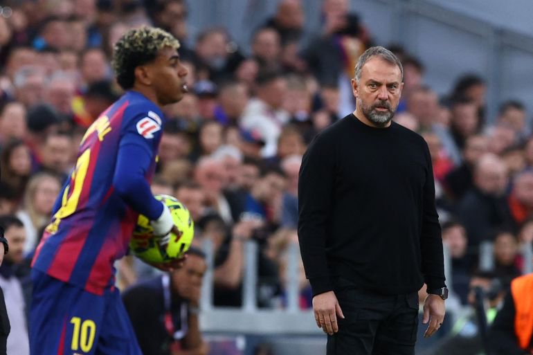 Barcelona coach Hansi Flick looks on as Lamine Yamal plays in a La Liga game