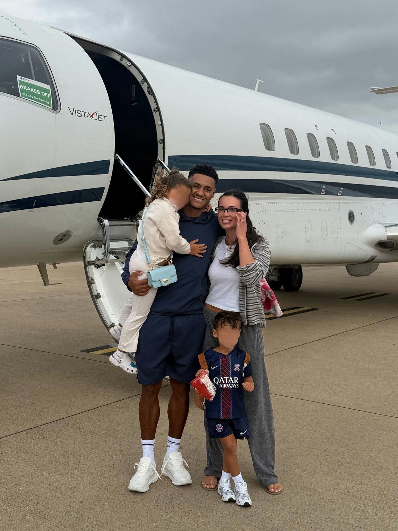 Ellie Watkins stood in front of a plane with her children and husband