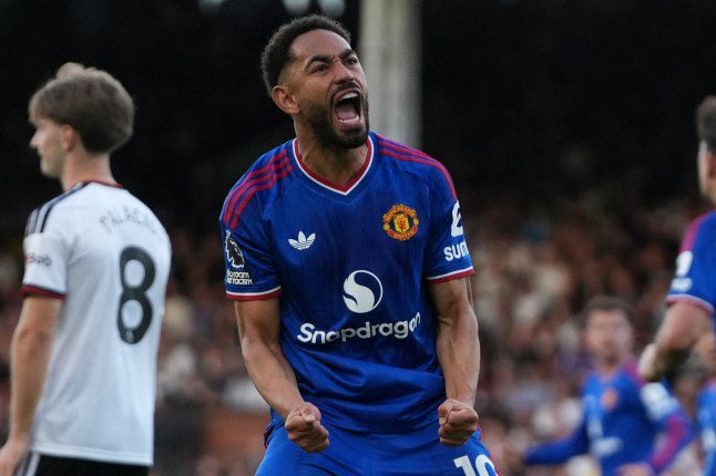Manchester United's Brazilian striker #10 Matheus Cunha celebrates after his deflected shot makes it 1-1 during the English Premier League football match between Fulham and Manchester United at Craven Cottage in London on September 20, 2026. (Photo by CARLOS JASSO / AFP via Getty Images) / RESTRICTED TO EDITORIAL USE. No use with unauthorized audio, video, data, fixture lists, club/league logos or 'live' services. Online in-match use limited to 120 images. An additional 40 images may be used in extra time. No video emulation. Social media in-match use limited to 120 images. An additional 40 images may be used in extra time. No use in betting publications, games or single club/league/player publications. /