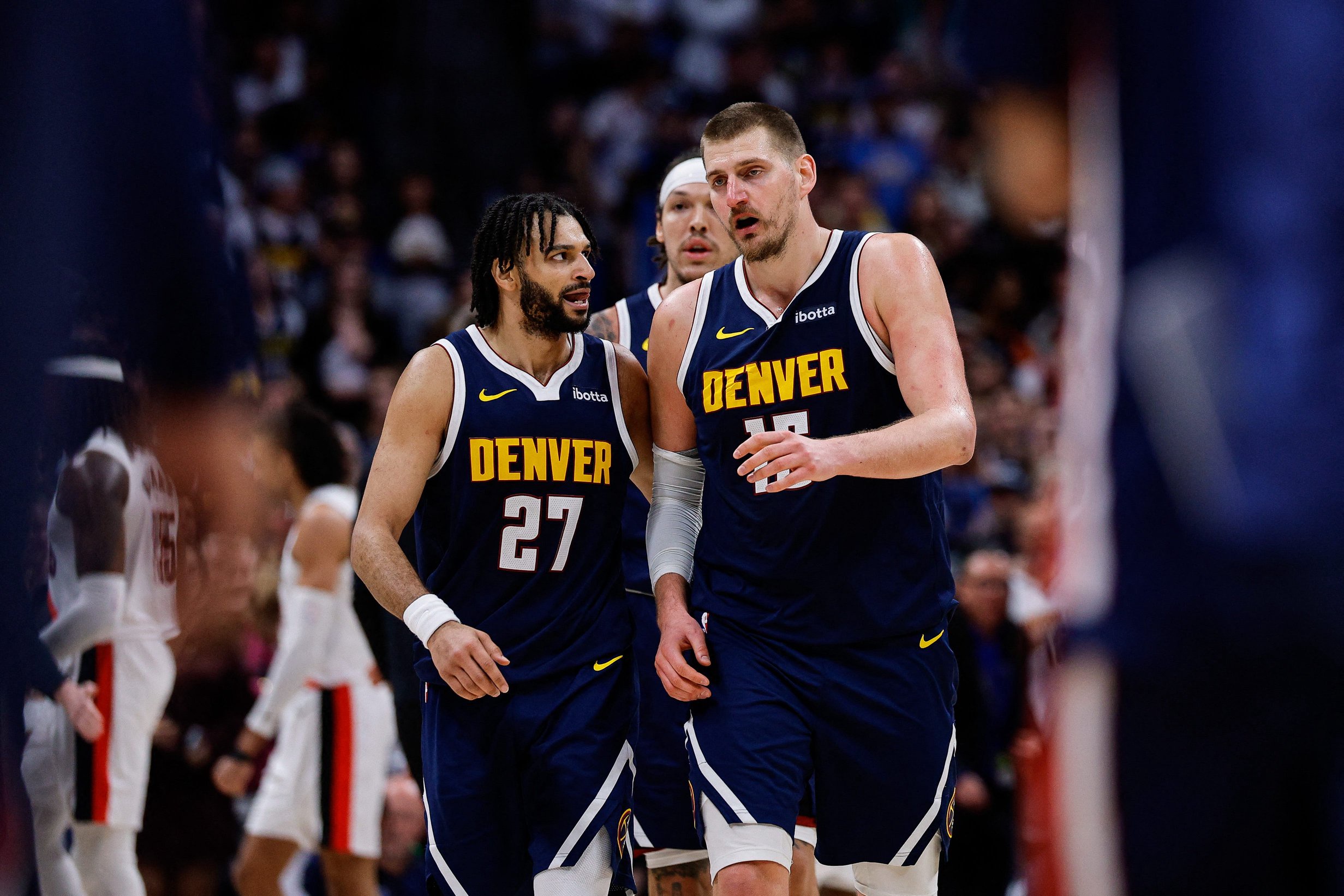 Denver Nuggets guard Jamal Murray (27) and center Nikola Jokic (15) in the fourth quarter against the Portland Trail Blazers at Ball Arena. 