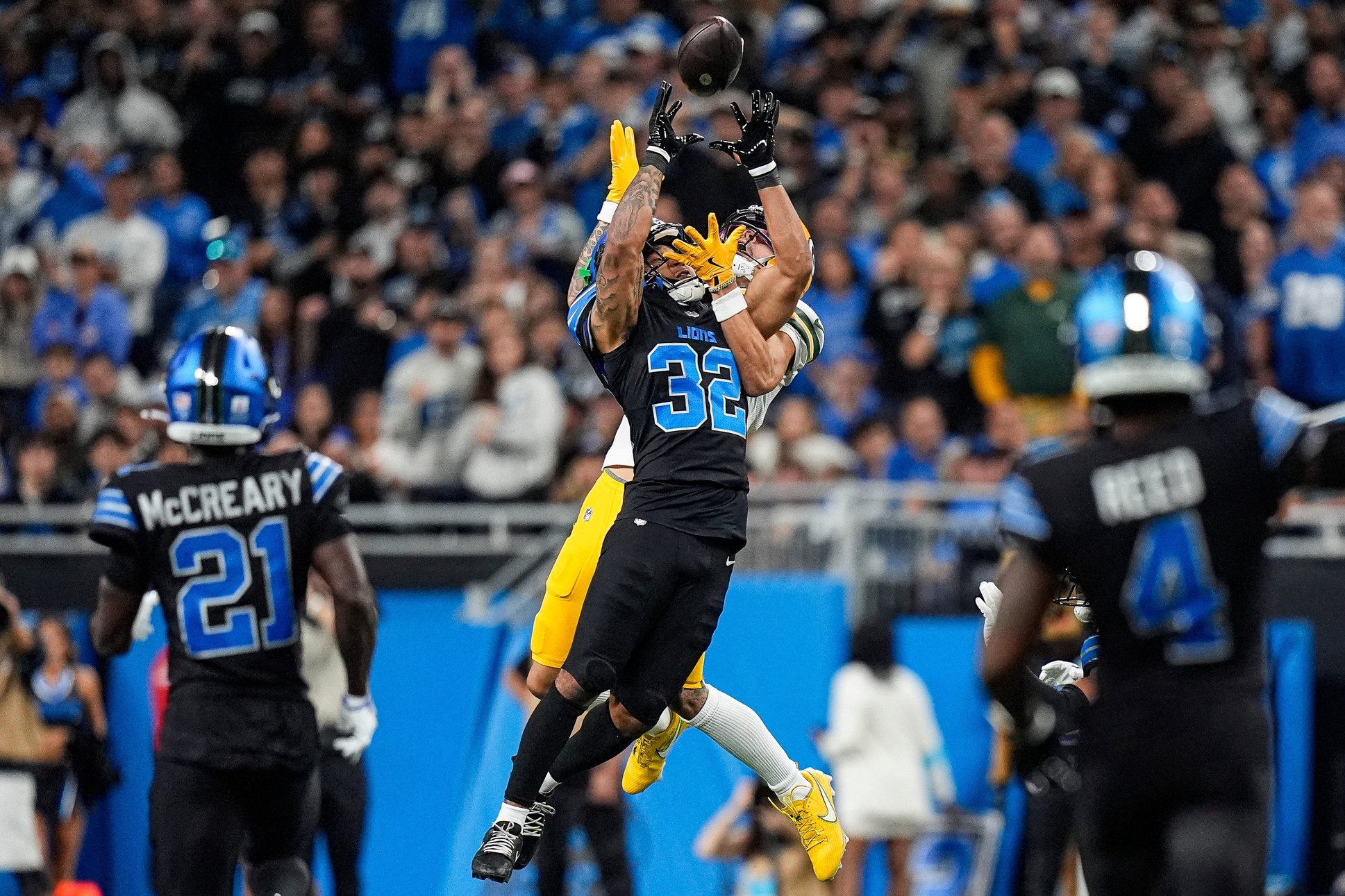 Detroit Lions defensive back Brian Branch intercepts a pass intended for Green Bay Packers wide receiver Christian Watson during the second half at Ford Field in Detroit on Sunday, Oct. 25, 2026.