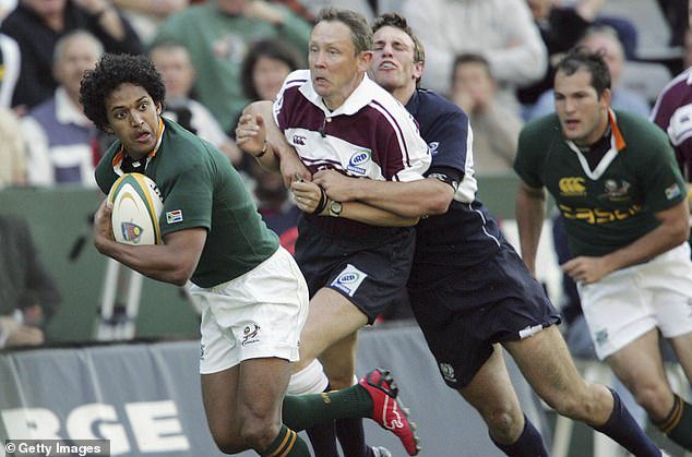 Donal Courtney is tackled by mistake by Mike Blair while refereeing an international between South Africa and Scotland at Kings Park in Durban in 2006