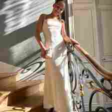 Harper Beckham wears an ivory dress