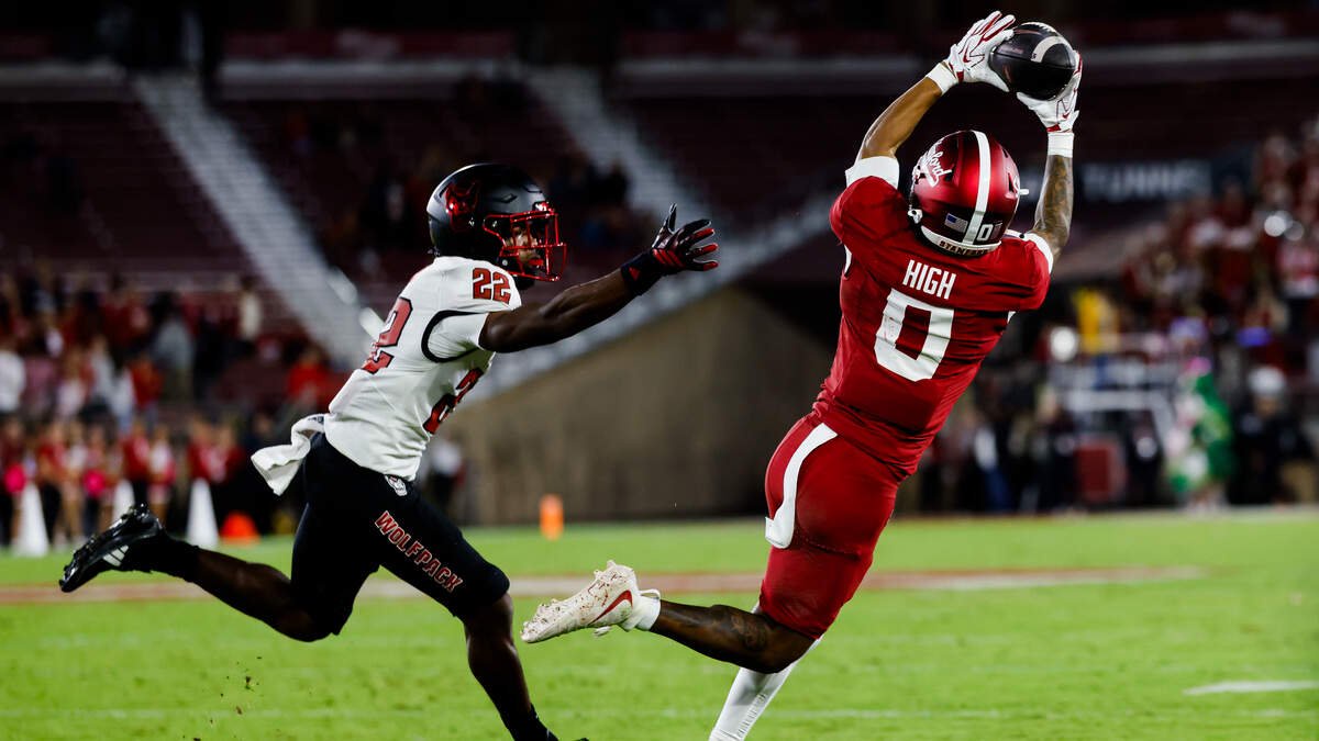 Oct 23, 2026; Stanford, California, USA; Stanford Cardinal wide receiver Caden High (0) makes a catch against NC State Wolfpack defensive back Jackson Vick (22) during the first quarter at Stanford Stadium. Mandatory Credit: Sergio Estrada-Imagn Images