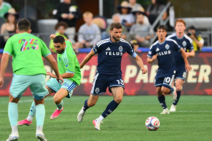 Vancouver Whitecaps FC forward Thomas Muller (13) advances the ball against the Seattle Sounders FC during the first half at Lumen Field.