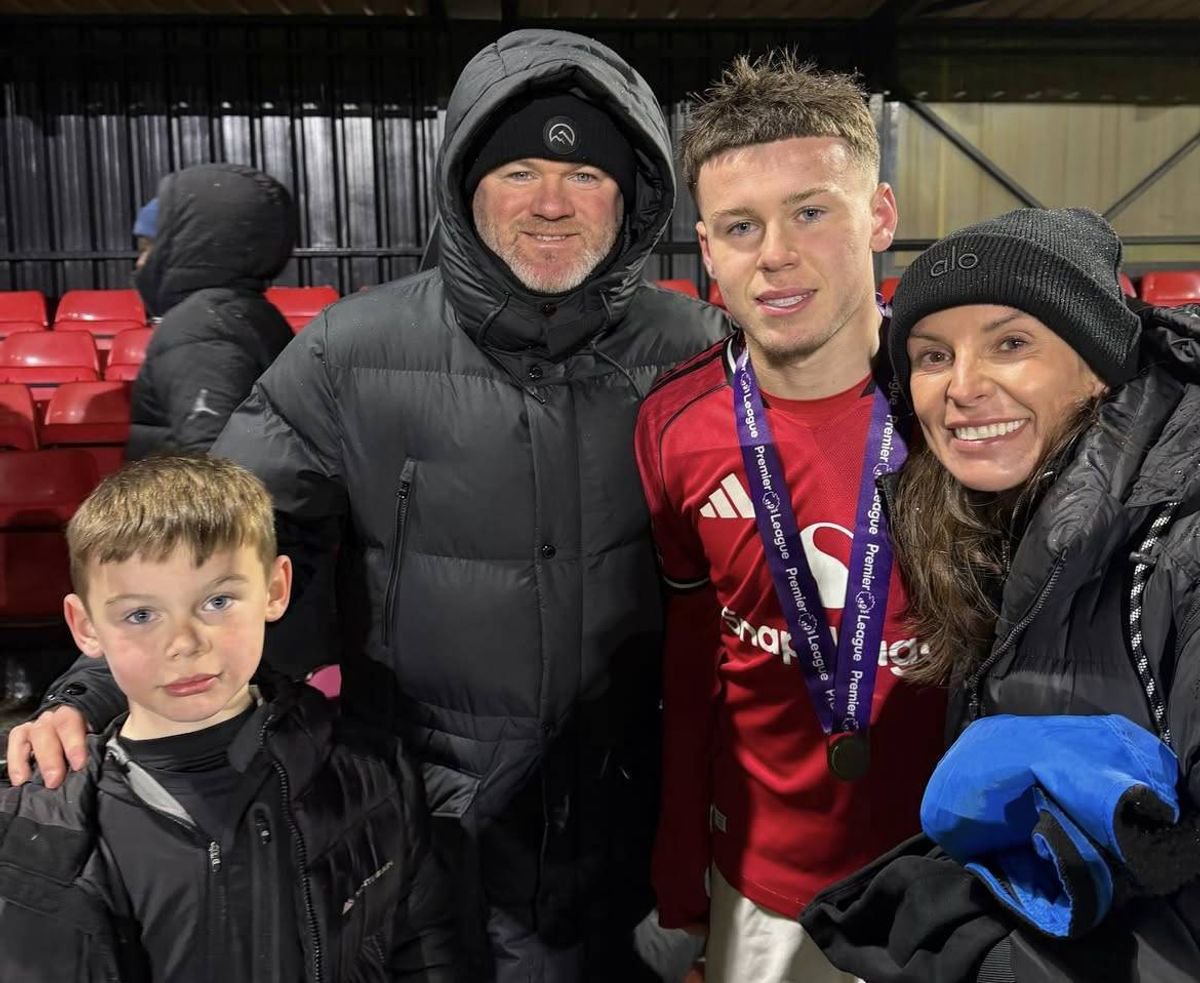 Kai Rooney with his parents after winning the Premier League Shield