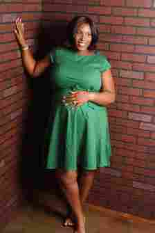 A reviewer wearing the knee-length, short-sleeve, A-line dress in green