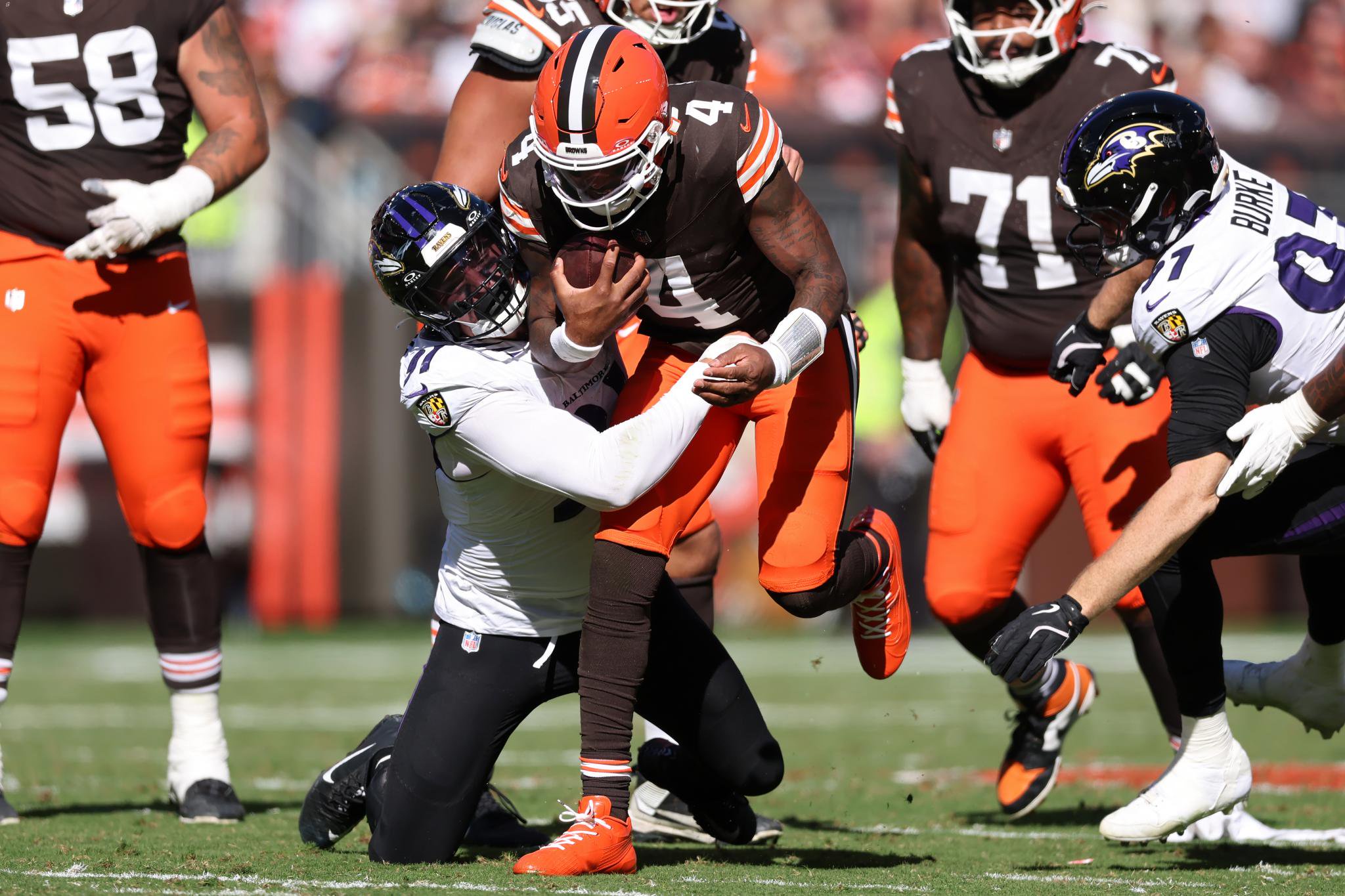Cleveland Browns quarterback Deshaun Watson (4) runs the ball against Baltimore Ravens defensive lineman Ethan Burke (97) during the third quarter of an NFL football game at Huntington Bank Field in Cleveland, Ohio, Sunday, Oct. 18, 2026.