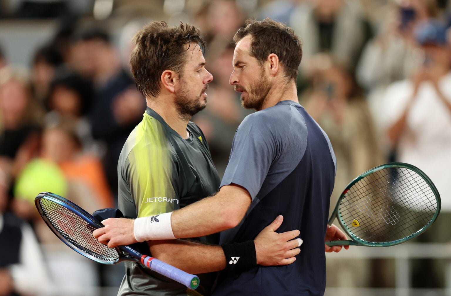 Andy Murray and Stan Wawrinka embrace.