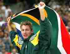 FILE -  Jacques Freitag of South Africa waves his national flag after he won the Men's high jump event at the World Athletics Championships, at the Stade de France in Saint Denis, north of Paris, Monday, Aug. 25, 2003. Local media is reporting that South African police have discovered the body of former high jump world champion Jacques Freitag after he went missing last month. The reports said the 42-year-old, who won the 2003 world title in Paris and competed at the 2004 Olympics, had been shot. (AP Photo/Thomas Kienzle, File)