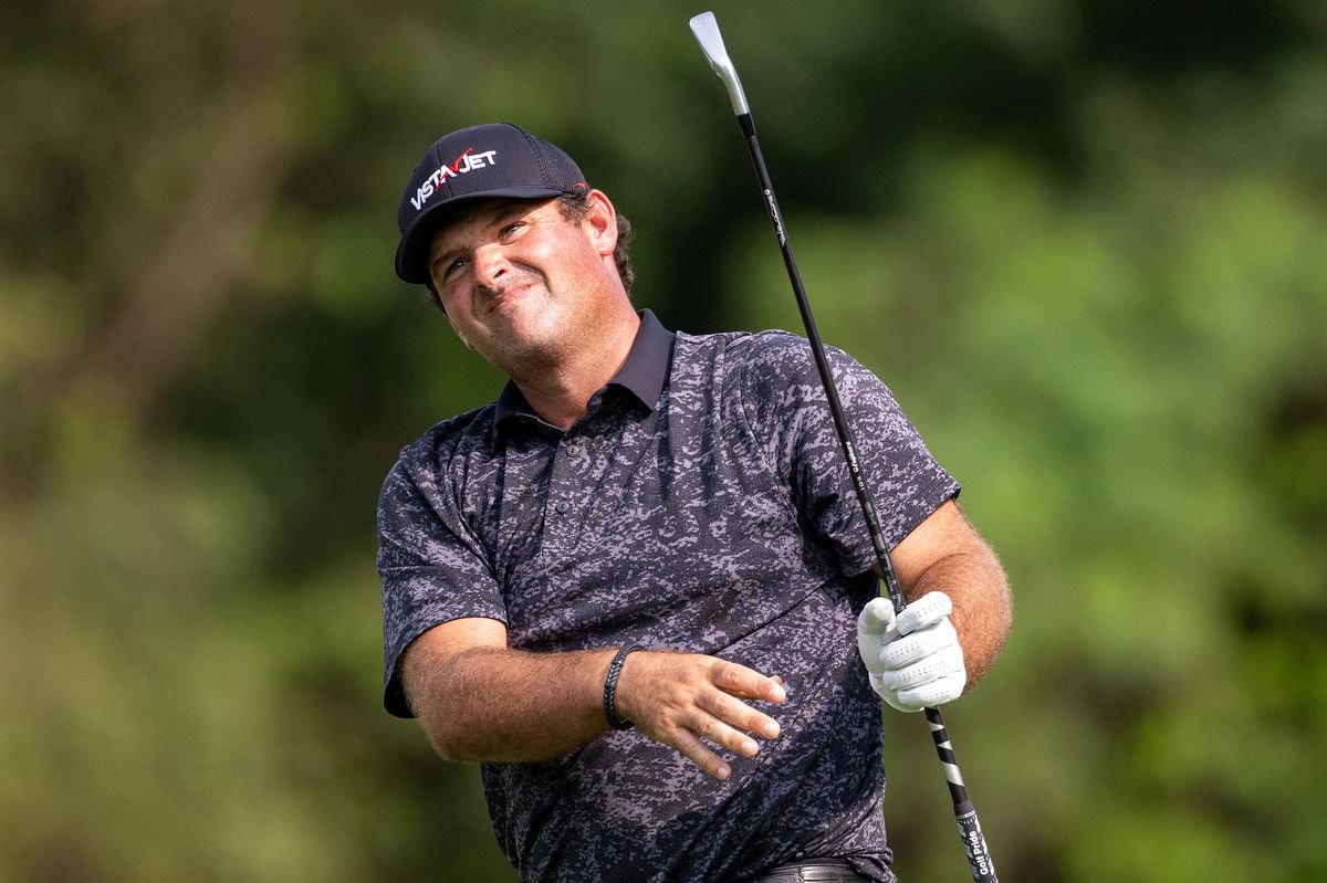 Patrick Reed watches on after hitting an iron shot