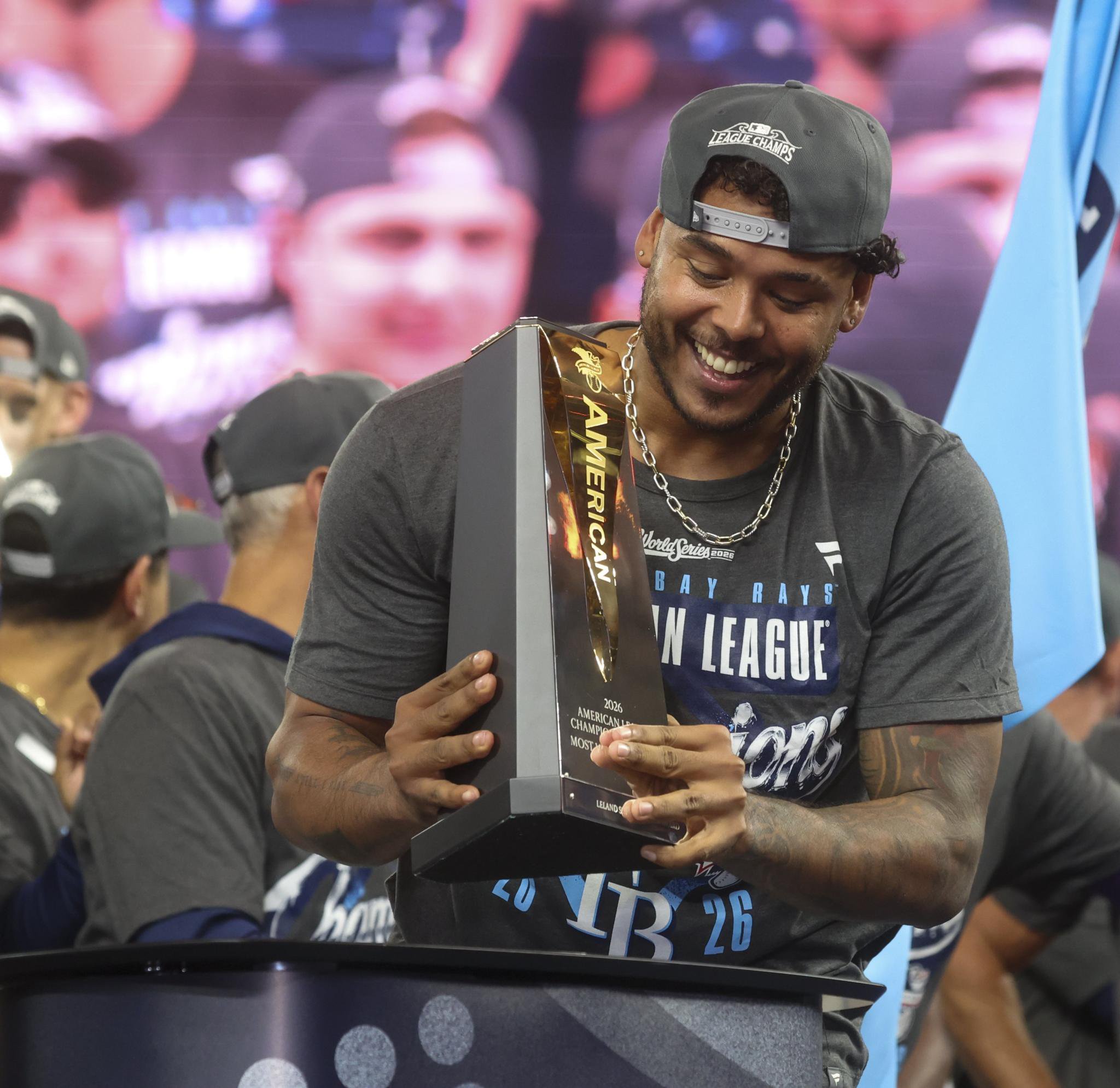 Tampa Bay Rays pitcher Freddy Peralta holds the William Harridge Trophy after winning the American League Championship Series.